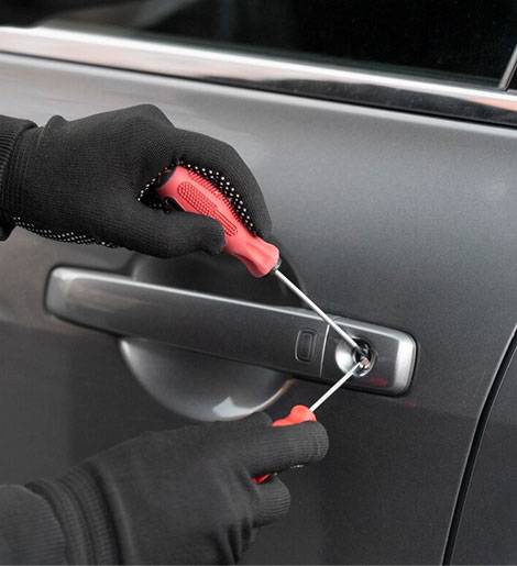 A person with gloves on and holding tools in their hand.